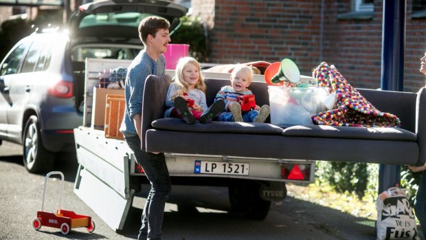 Family moving with kids and stuff on a sofa