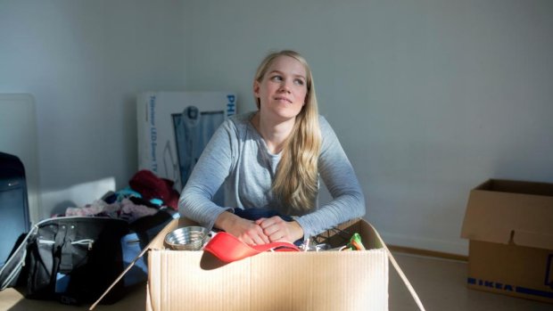 Young female with all her belongings in a box