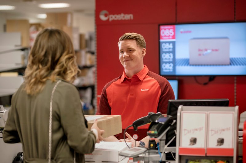 Woman delivering a parcel at the post office