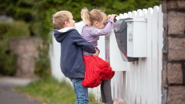 Children looking in the mailbox