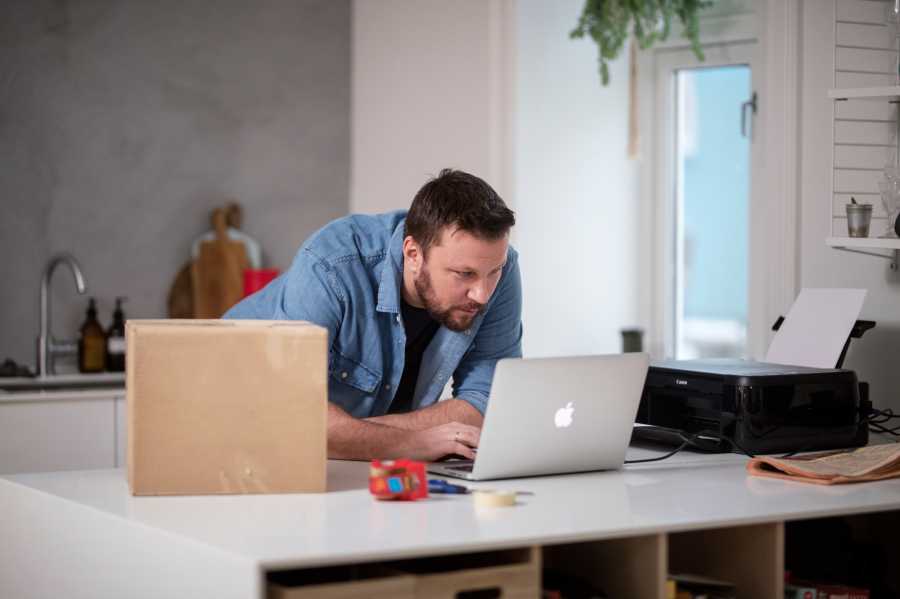 Man getting ready to send a parcel from home