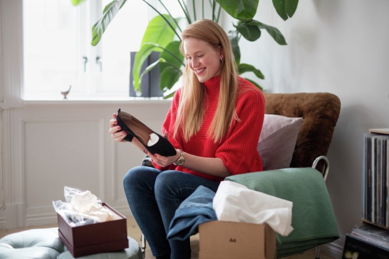 A woman preparing a parcel for return